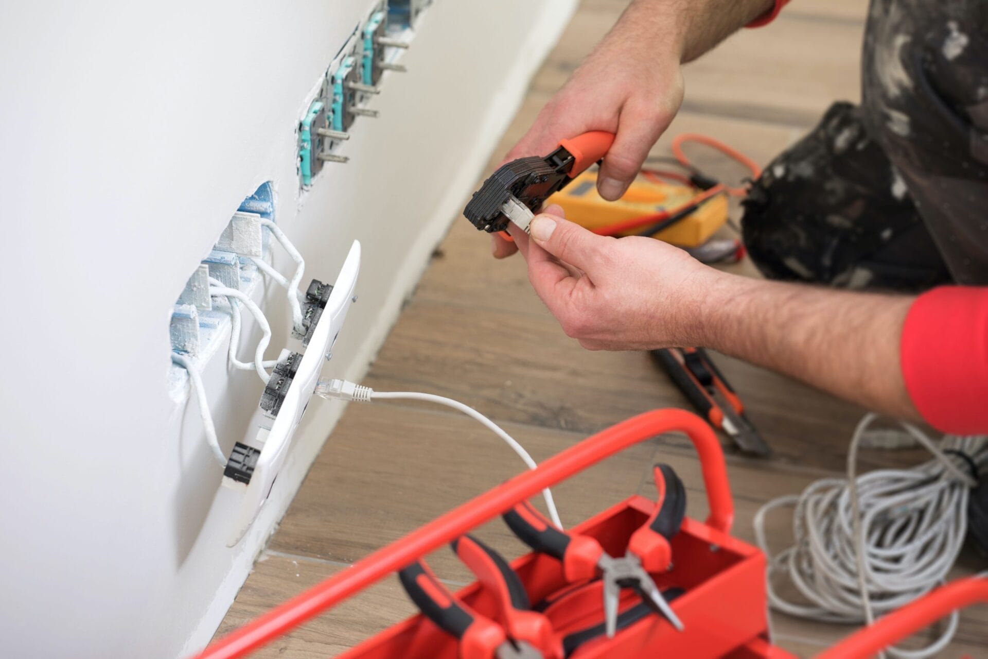 Residential electrician installing outlets in house